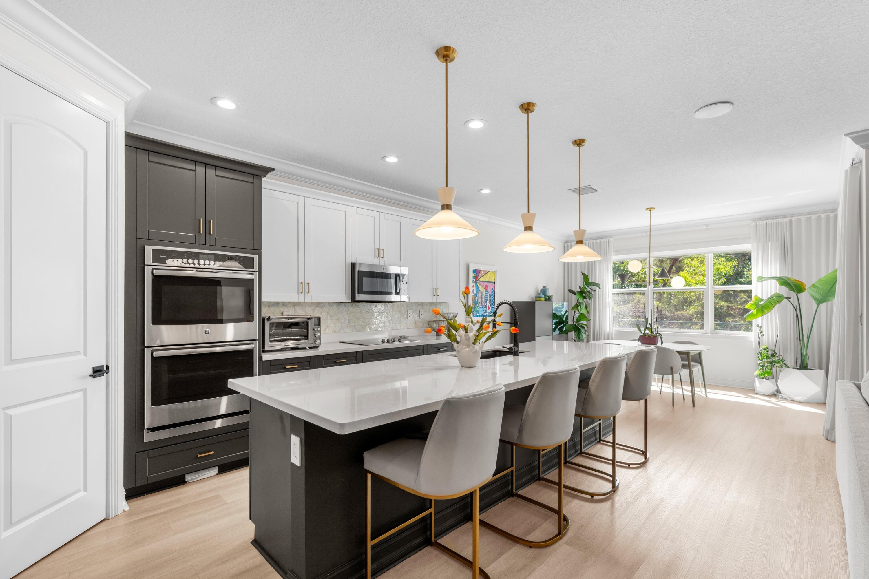 100 Northwest 69th Circle, Unit 82 Boca Raton, FL 33487 - Photo 6 of 42 a kitchen with kitchen island a large counter top space appliances and cabinets