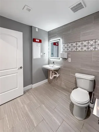 a white toilet sitting next to a bathroom sink