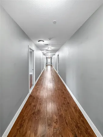 a view of a room with wooden floor and window