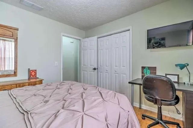 a bedroom with a bed and a chair in it