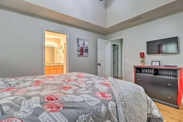 a bedroom with a bed and a flat screen tv