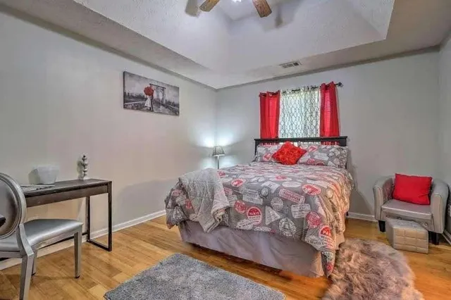 a bedroom with a bed a study table and chair