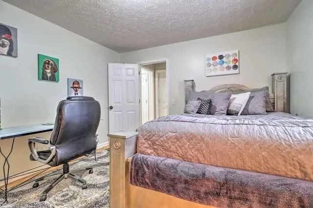 a bedroom with a bed and chair