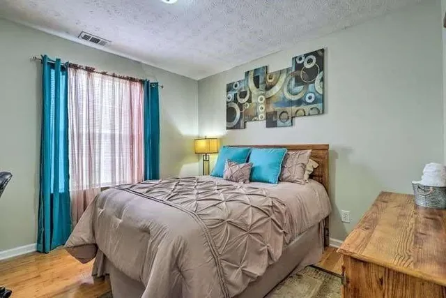 a bedroom with a bed and a window