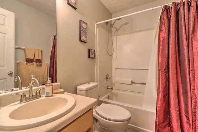 a bathroom with a sink toilet and shower