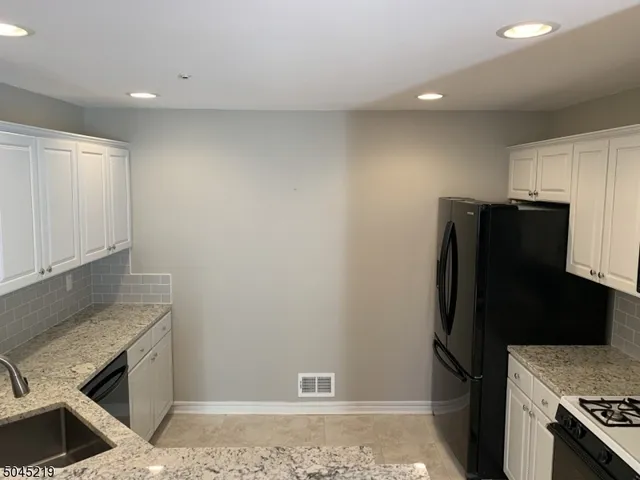 a refrigerator freezer sitting inside of a kitchen