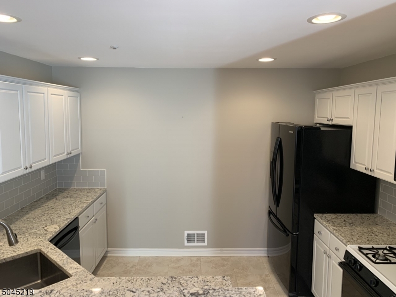 13 Potomac Drive, Unit 13 Bernards, NJ 07920 - Photo 3 of 16 a refrigerator freezer sitting inside of a kitchen