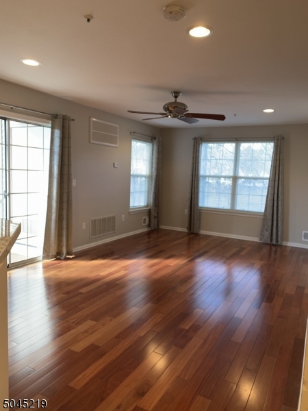 13 Potomac Drive, Unit 13 Bernards, NJ 07920 - Photo 4 of 16 an empty room with wooden floor and windows
