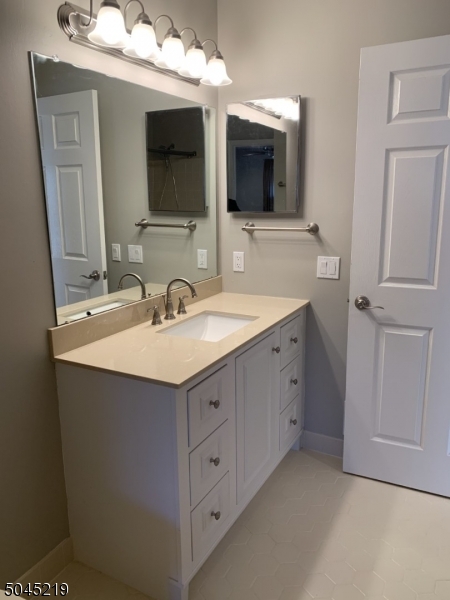 13 Potomac Drive, Unit 13 Bernards, NJ 07920 - Photo 5 of 16 a bathroom with a sink and a mirror