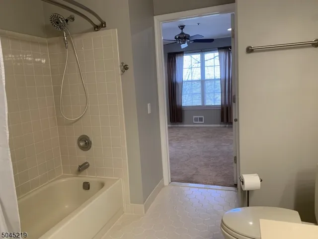 a bathroom with a granite countertop toilet a sink and bathtub