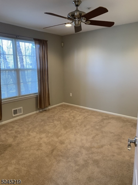 13 Potomac Drive, Unit 13 Bernards, NJ 07920 - Photo 7 of 16 an empty room with windows and fan
