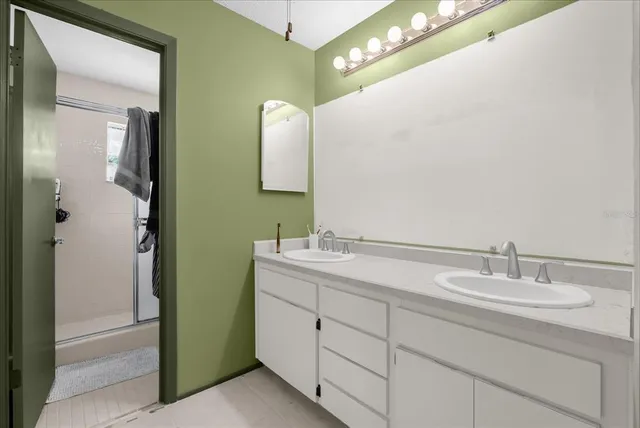 a bathroom with a double vanity sink and mirror