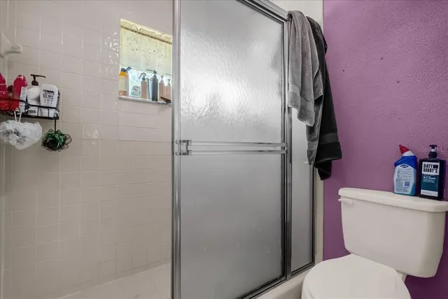 a white toilet sitting next to a bathroom sink and vanity