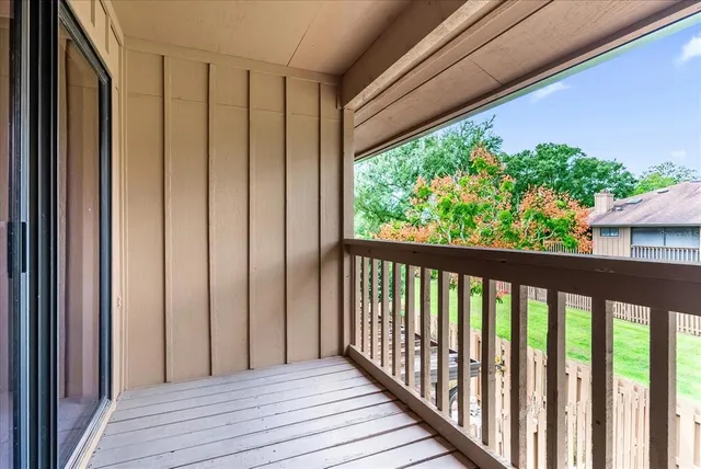 a view of a balcony with wooden floor