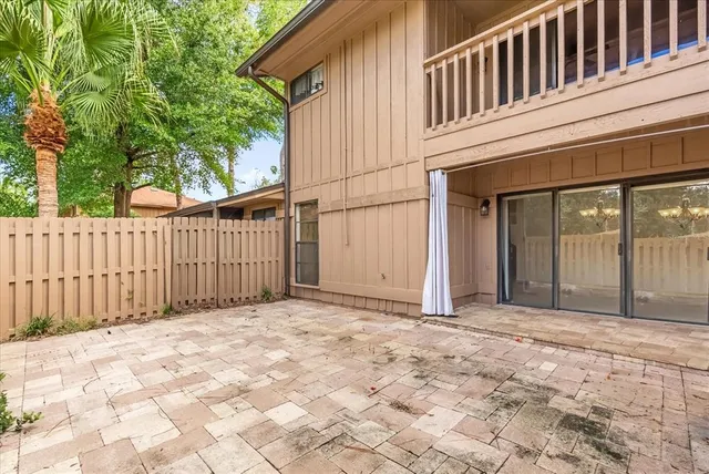 a view of a house with a wooden fence