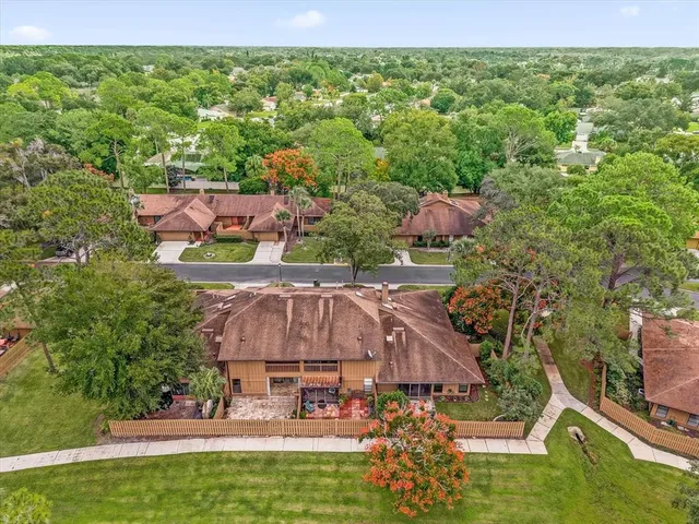 an aerial view of a house with garden space and street view