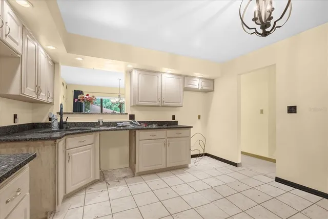 a kitchen with a sink cabinets and window