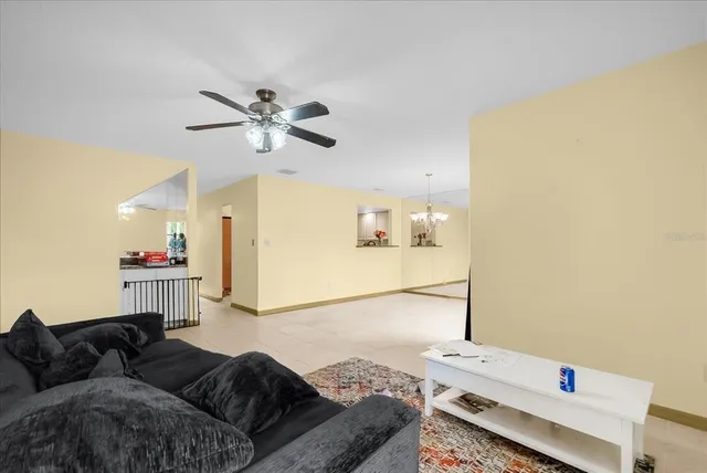 a living room with furniture and a ceiling fan