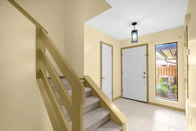 a view of a hallway with windows and entryway