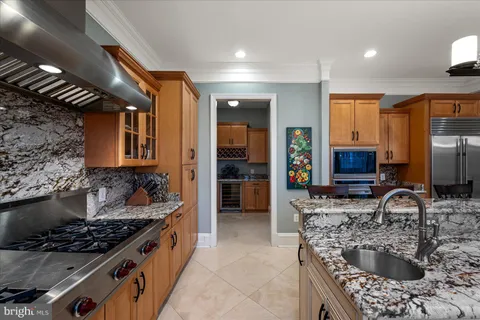 a kitchen with stainless steel appliances granite countertop a stove and a microwave