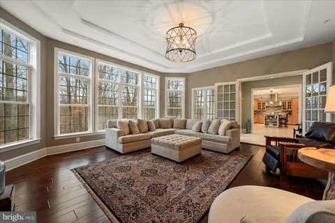a living room with furniture and floor to ceiling windows