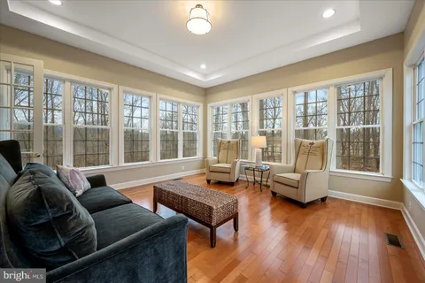 a view of a livingroom with wooden floor and furniture