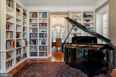 a bedroom with bed couch and large window