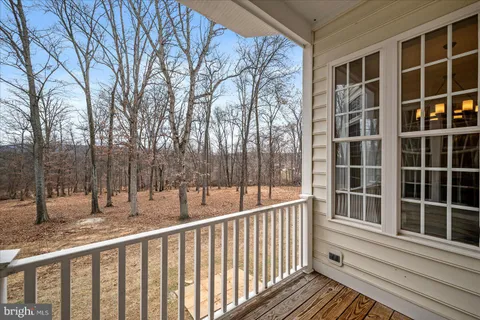 a bathroom with a granite countertop toilet sink and mirror