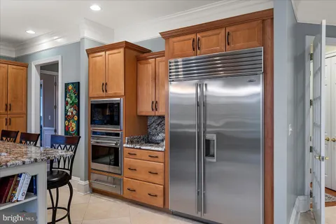 a kitchen with stainless steel appliances granite countertop a sink and stove