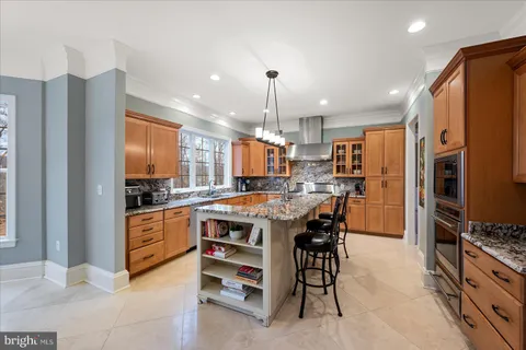 a bathroom with a granite countertop sink and a window