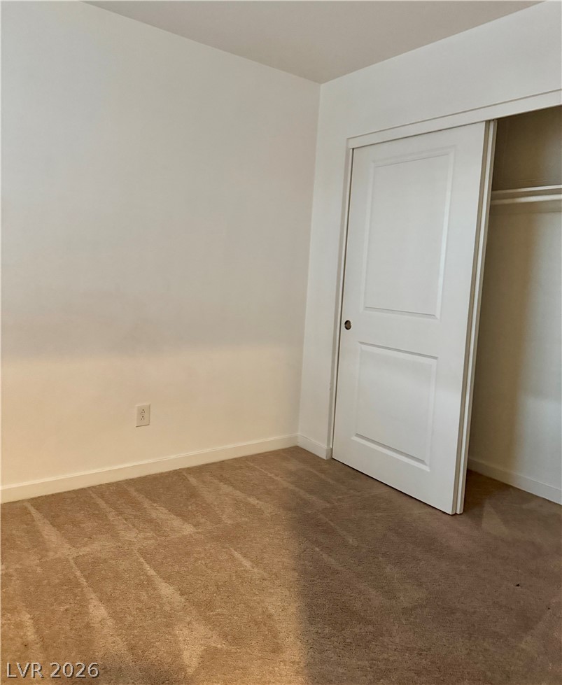1892 Via Del Rey Court Las Vegas, NV 89115 - Photo 6 of 10 A well-maintained carpeted floor anchors this adaptable bedroom space.