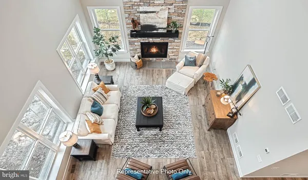 a living room with furniture a fireplace and a wooden floor
