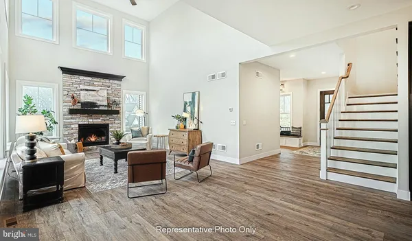a living room with furniture a fireplace and a wooden floor