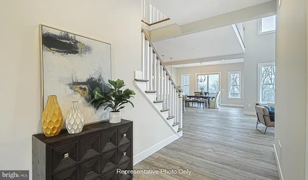 a view of a hallway view with wooden floor and staircase