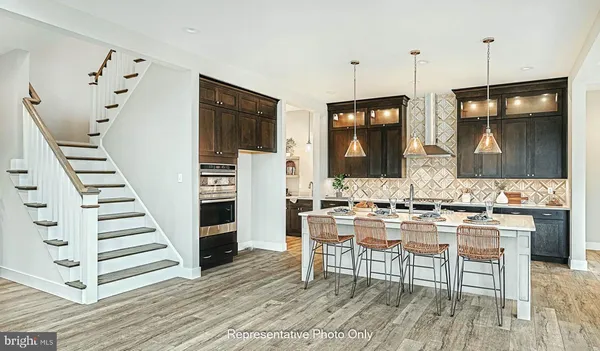 a view of kitchen with cabinets and wooden floor