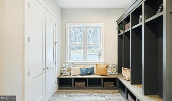 a view of a bedroom with furniture and window