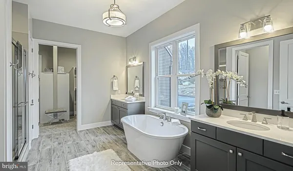 a bathroom with a double vanity sink mirror and toilet