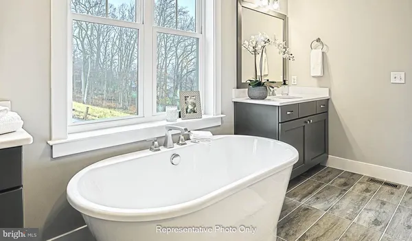 a white bath tub sitting next to a white sink