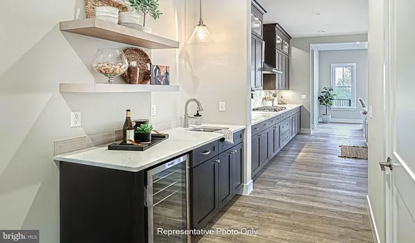 a kitchen with sink cabinets and wooden floor