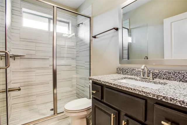 a bathroom with a sink a toilet and mirror