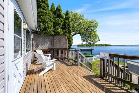a view of balcony with wooden floor and seating space