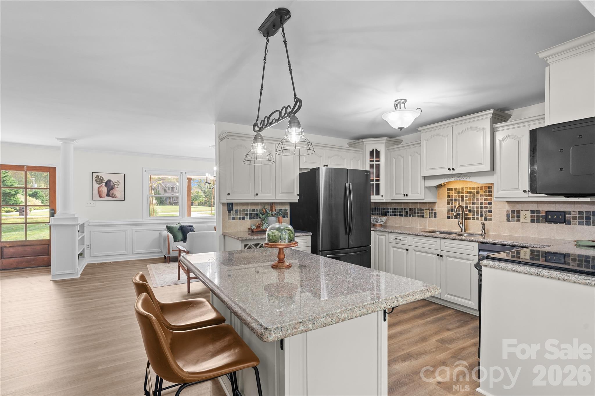 1335 Blacksnake Road Stanley, NC 28164 - Photo 8 of 31 a kitchen with refrigerator cabinets and wooden floor