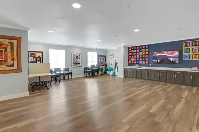 a view of a livingroom with furniture and a flat screen tv