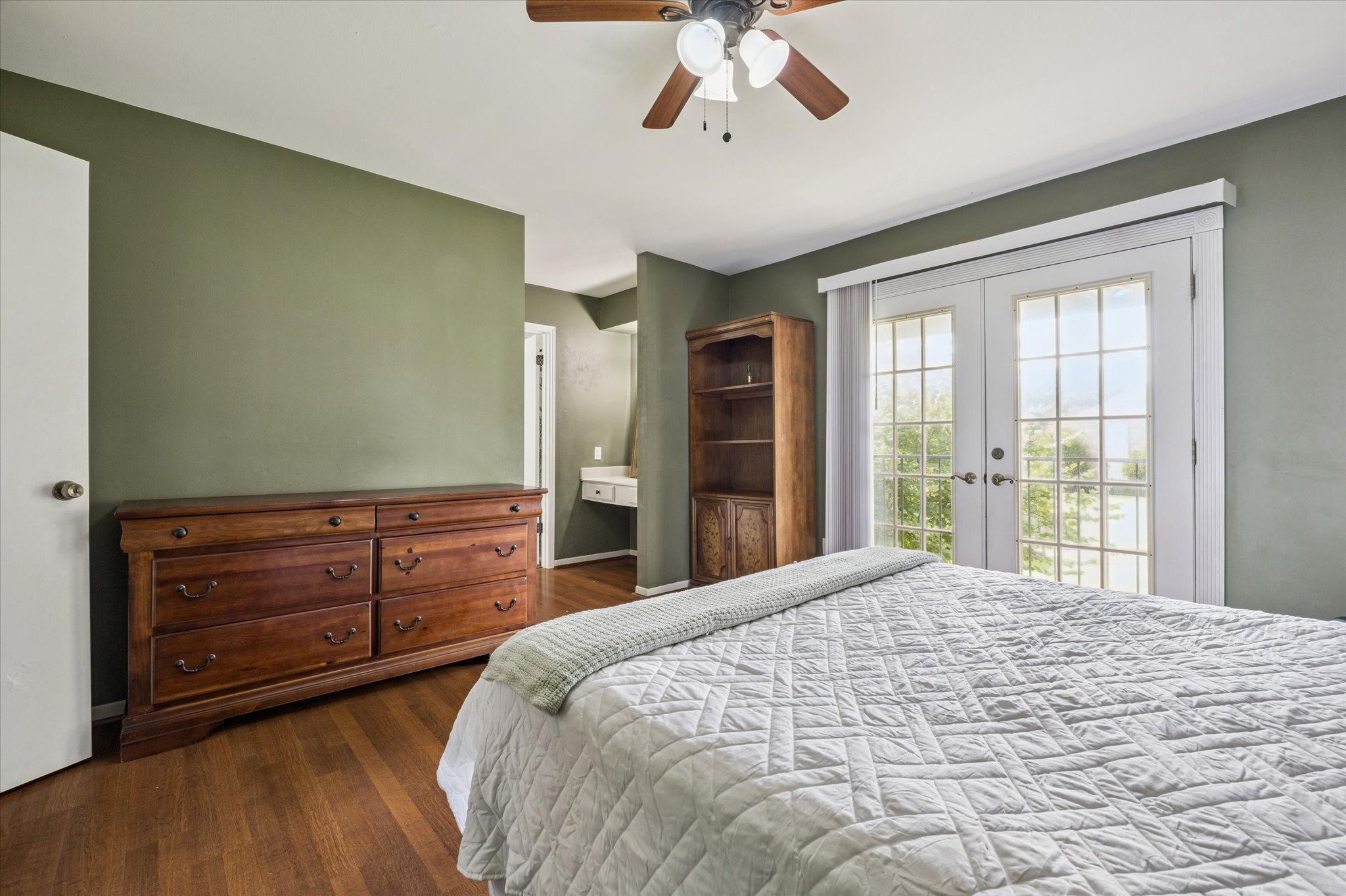 6517 Wanda Lane Houston, TX 77074 - Photo 22 of 36 Another view of the primary bedroom. Wood flooring-no carpet! There is a vanity area before entering the primary bathroom. A walk-in closet is across from the vanity desk.