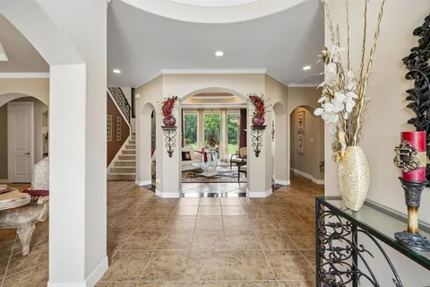 a view of a hallway with living room and dining room