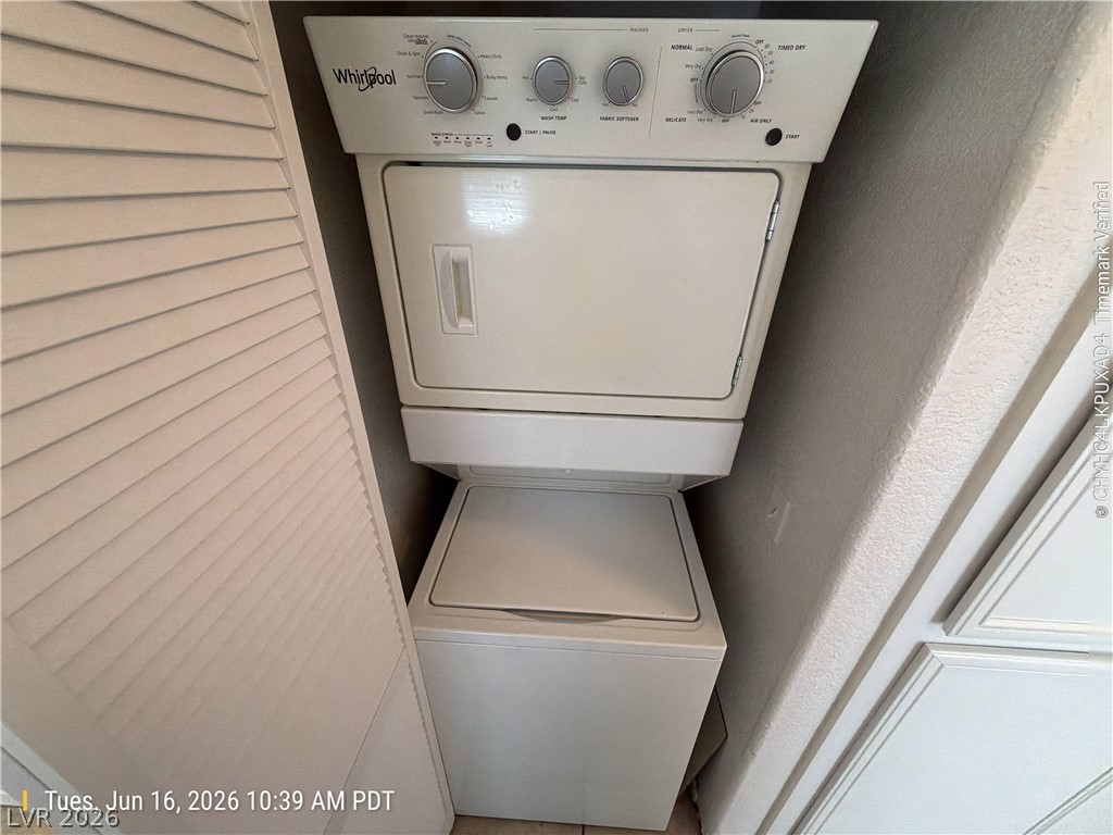 4730 East Craig Road, Unit 1124 Las Vegas, NV 89115 - Photo 13 of 22 A compact laundry closet featuring a stacked washer and dryer, ready for household tasks.