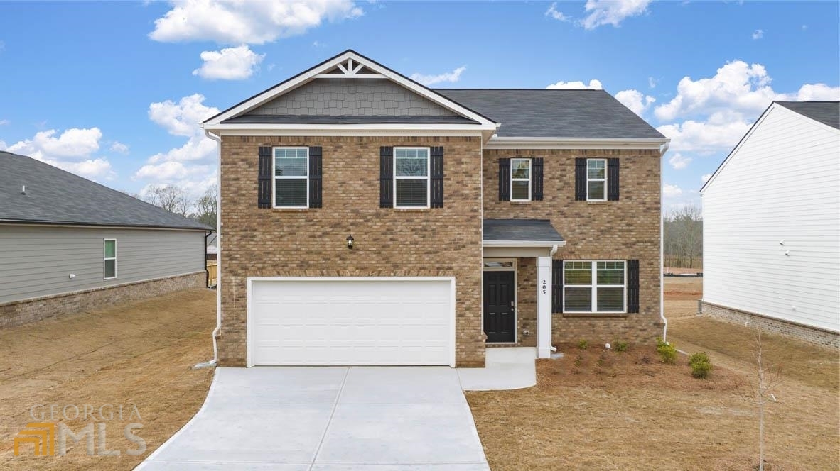 688 Whitman Lane, Unit 48 Stockbridge, GA 30281 - Photo 1 of 1 a front view of a house with a yard and garage