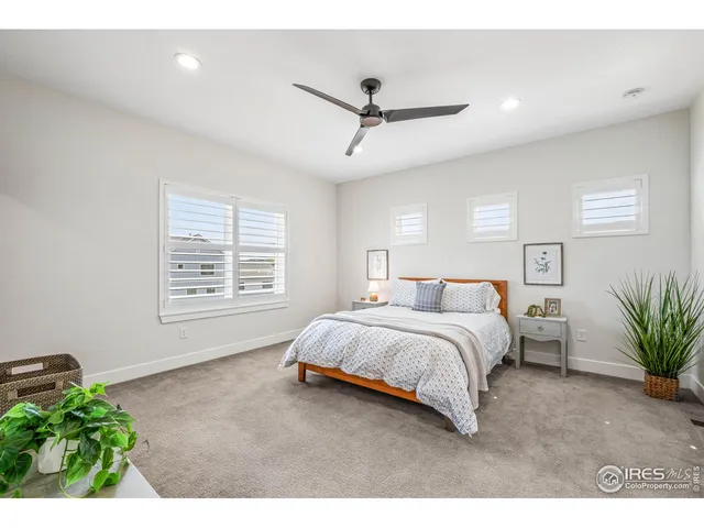 a spacious bedroom with a bed window and table