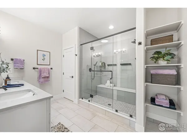a bathroom with a sink mirror and shower