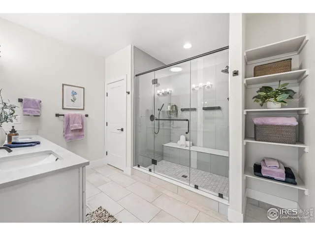 a bathroom with a sink mirror and shower